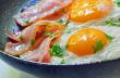 fried egg with bacon in a frying pan