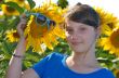 Young beautiful girl in a sunflower field