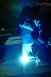 welder with protective mask welding metal 