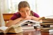 Teen girl learning at the desk, looking up