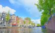 Traditional Houses and house boat along canal in Amsterdam
