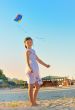 Girl on beach with kite 