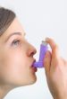 girl using an inhaler for Asthma