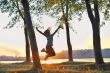 girl jumping over sunset