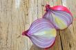 Red onions isolated on wooden background