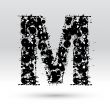 Letter M formed by inkblots