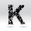 Letter K formed by inkblots