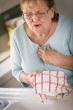 Senior Adult Woman At Sink With Chest Pains