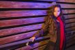 Mixed Race Young Adult Woman Against a Wood Wall Background