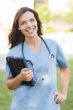 Young Adult Woman Doctor or Nurse Holding Touch Pad