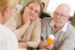 Doctor or Nurse Explaining Prescription Medicine to Senior Coupl