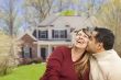 Happy Mixed Race Couple in Front of House