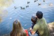 Mixed Race Mother and Father with Son at the Pond