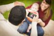 Happy Mixed Race Parents and Baby Boy Taking Self Portraits