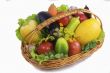 Basket with fruits and vegetables , photographed on a white back