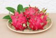 dragon fruits in basket on wooden desk