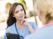 Two Young Adult Female Doctors or Nurses Talking Outside