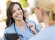 Two Young Adult Female Doctors or Nurses Talking Outside