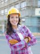 Young Attractive Female Construction Worker Wearing Hard Hat and