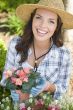 Young Adult Woman Wearing Hat Gardening Outdoors