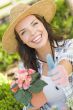 Young Adult Woman Wearing Hat Gardening Outdoors