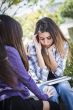 Stressed Sad Young Mixed Race Girl Being Comforted By Friend