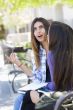 Expressive Young Mixed Race Female Sitting and Talking with Girl