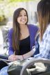Expressive Young Mixed Race Female Sitting and Talking with Girl