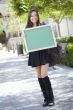 Excited Mixed Race Female Student Holding Blank Chalkboard
