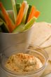hummus dip with pita bread and vegetable