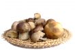 Mushrooms in a wicker dish on a white background.