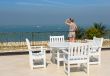 Young beautiful girl on the balcony of the hotel and looks into 