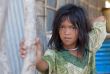 A young girl lives in a fishing village and tourist poses for a 