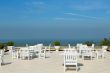 An empty rooftop restaurant with views of the sea
