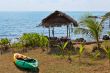 Plastic kayak on the shore next to the hut