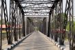 Road through metal bridge tunnel