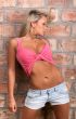 glamorous girl in a pink shirt with a naked belly