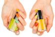 Women`s hands with a colored nail varnish
