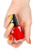 A bottle of red nail polish in a female hand