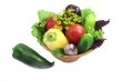 Basket with fruits and vegetables , photographed on a white back