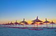 Sunrise under parasol on the beach