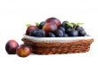 Plums and prunes in a vase for fruit on a white background.