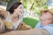 Mixed Race Couple with Guitar and Cowboy Hat in Park