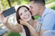 Mixed Race Couple Taking Self Portrait in Park