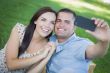 Mixed Race Couple Taking Self Portrait in Park