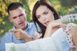Lost and Confused Mixed Race Couple Looking Over Map Outside