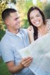 Mixed Race Couple Looking Over Map Outside Together