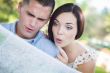 Mixed Race Couple Looking Over Map Outside Together