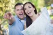 Mixed Race Couple Looking Over Map Outside Together