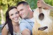 Mixed Race Couple Portrait with Guitar in Park